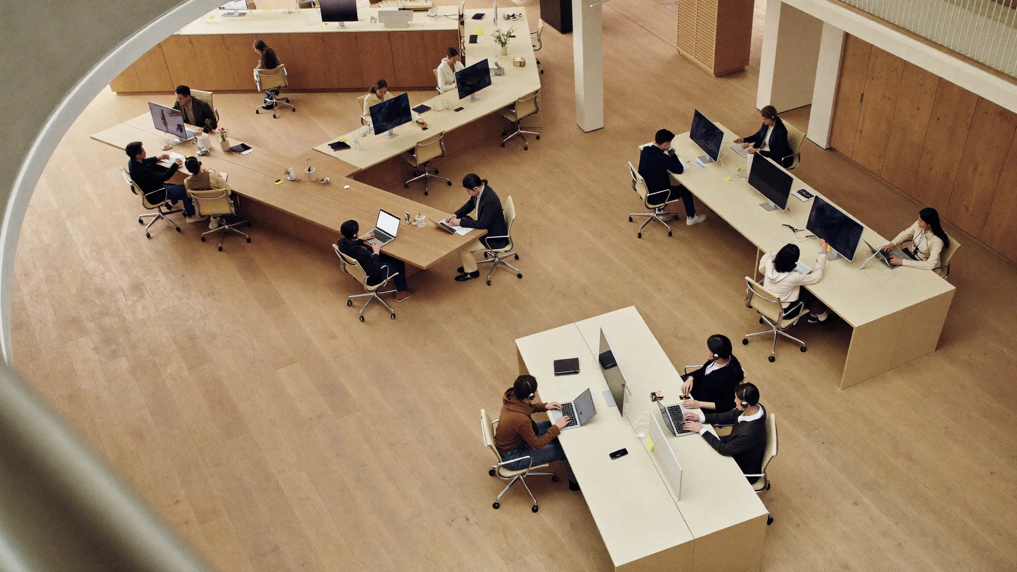 An overhead view of a revenue operations floor: SDR, AE and CS pods at work