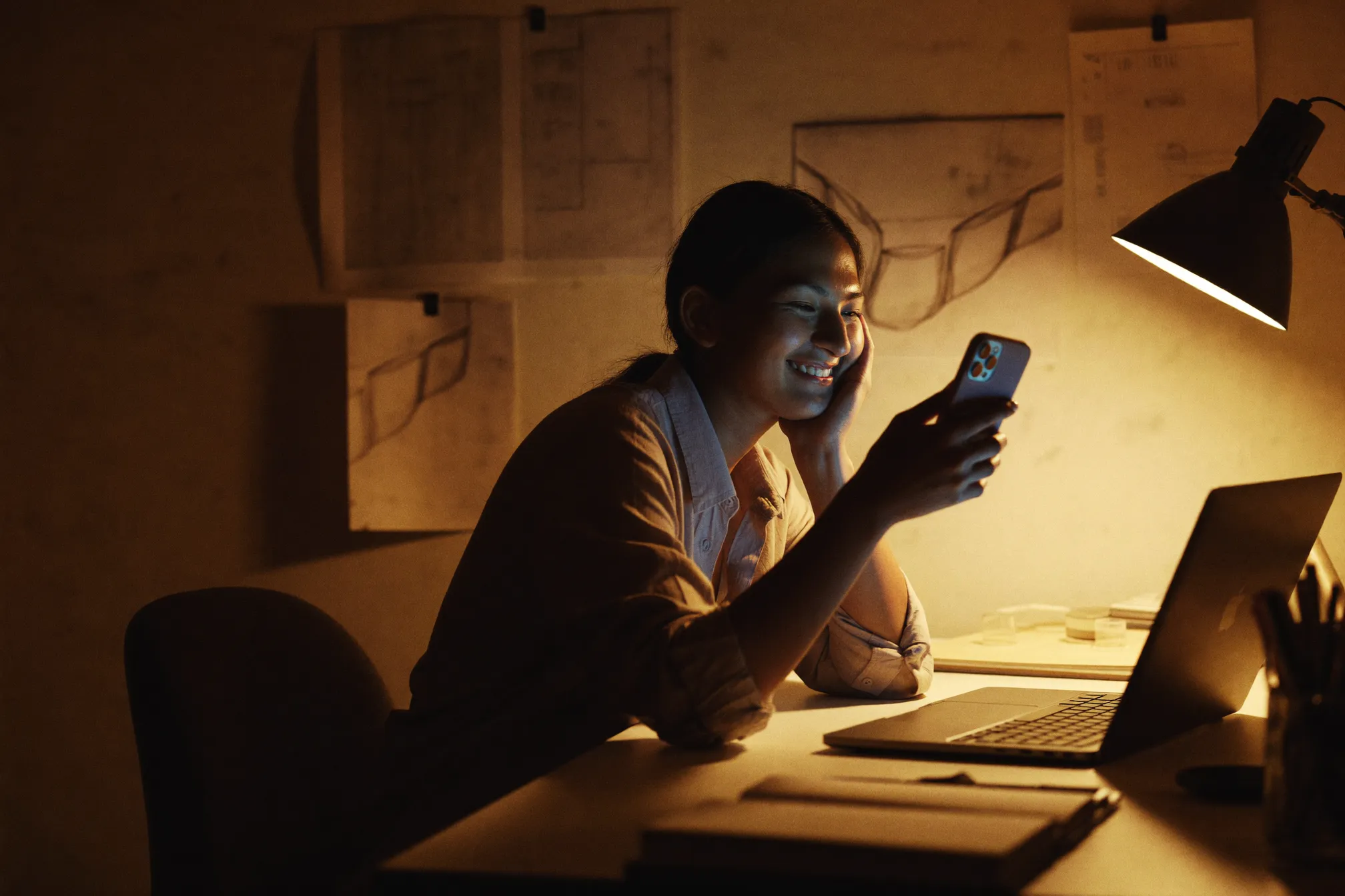 A founder working late at night, lit by the glow of a laptop