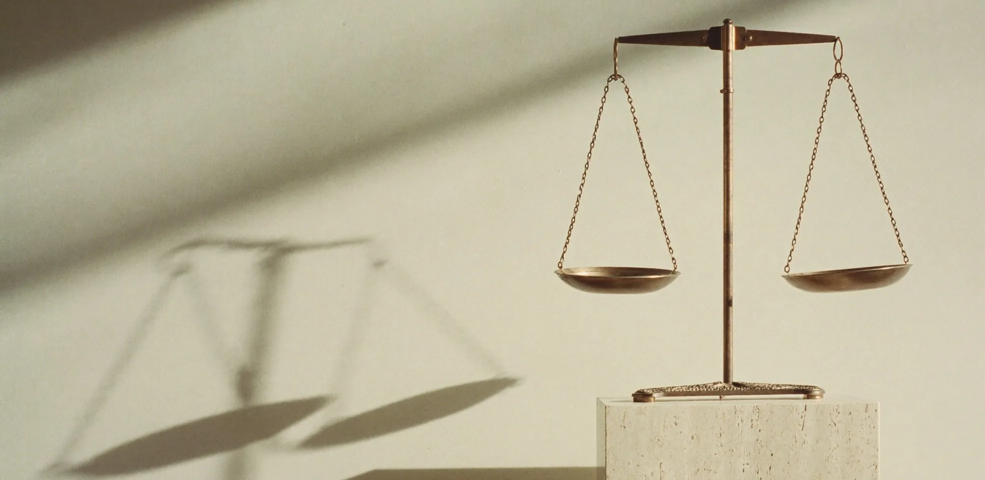 An empty balance scale on a stone plinth